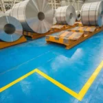 Stacked rolls of steel in a factory setting in Michigan and Ohio