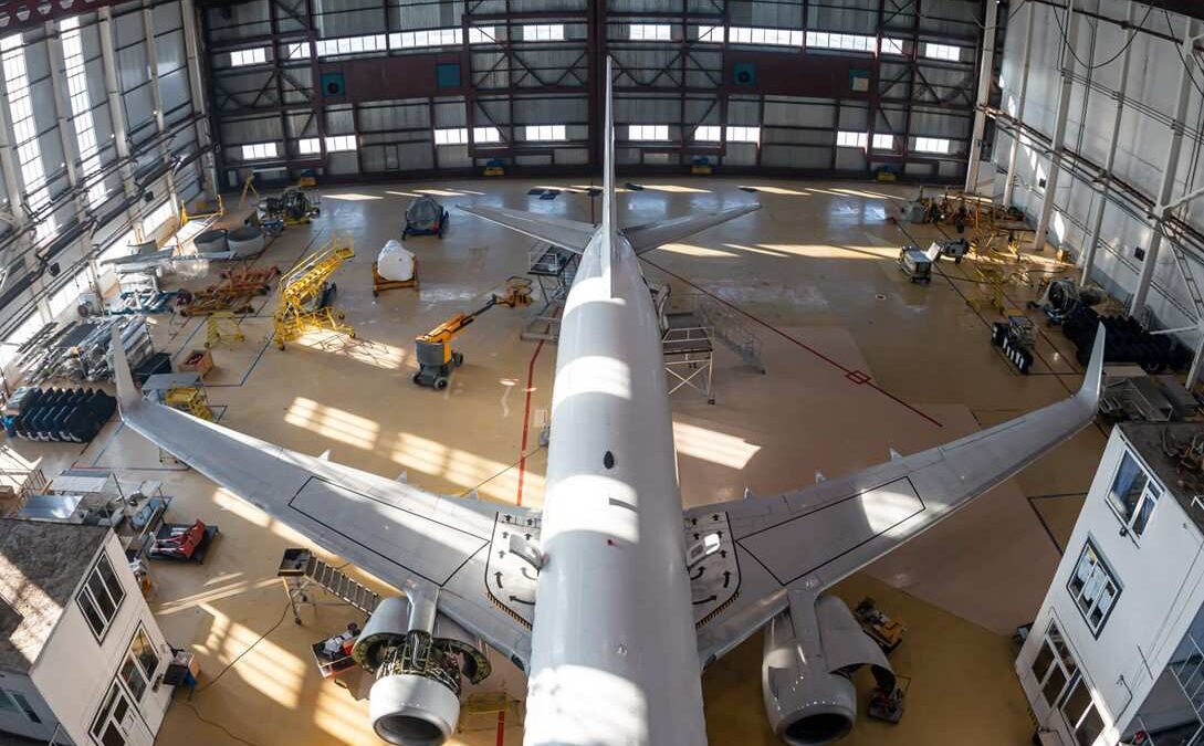Airplane parked in a hangar showcasing flooring solutions for aviation facilities in St. Clair, MI