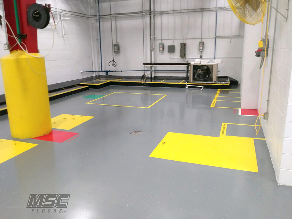 Epoxy flooring with safety markings in utility room serving Michigan, Ohio and Indiana