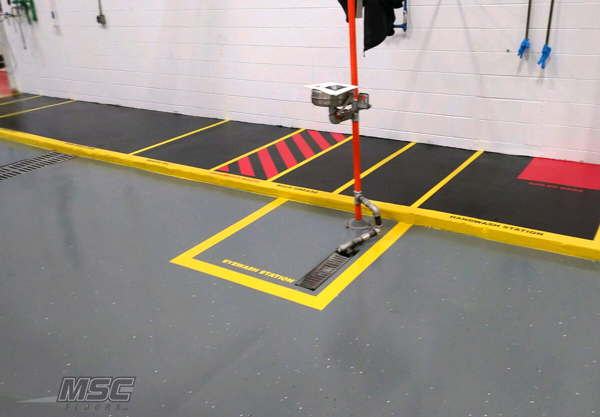 Industrial epoxy floor with safety striping and drainage serving Michigan, Ohio and Indiana
