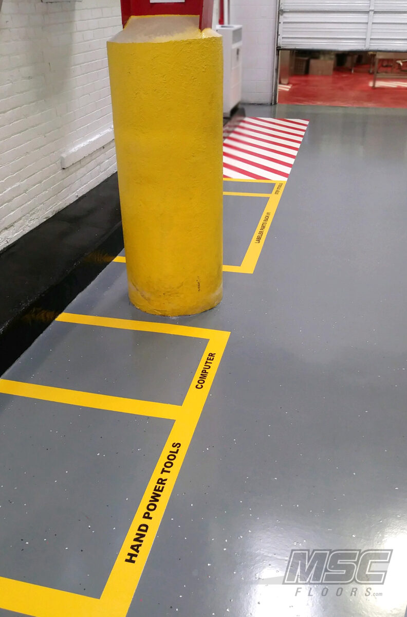 Industrial epoxy flooring with labeled work zones and striping serving Michigan, Ohio and Indiana
