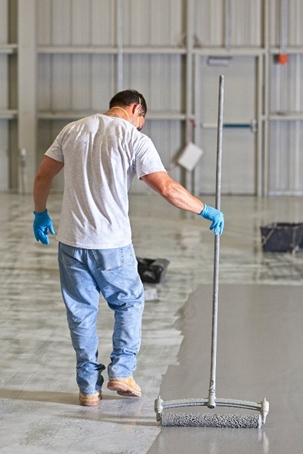 Individual working with epoxy flooring in Cleveland, OH