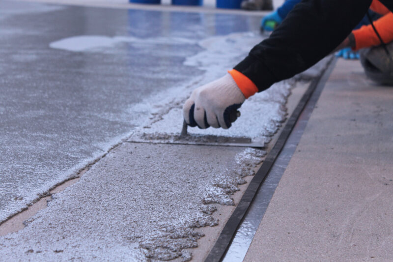 Worker laying paint strip in Indiana factory in Ohio