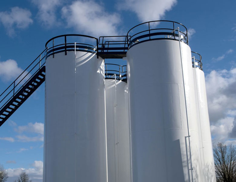 Large white silos with a ladder